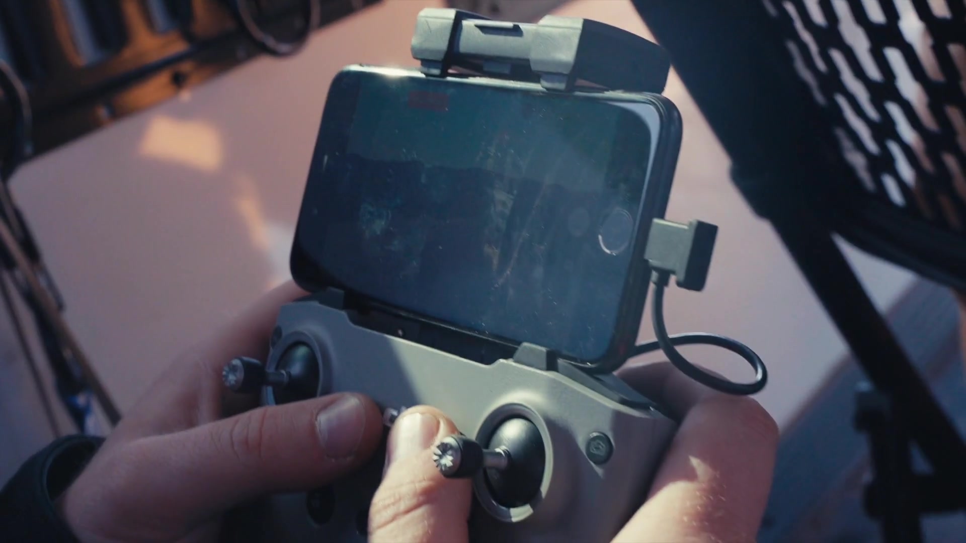 Documentary close-up of hands operating a controller during field work